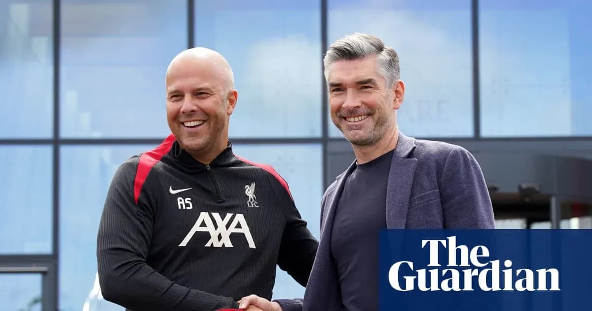 Two men shaking hands outside Liverpool FC facility
