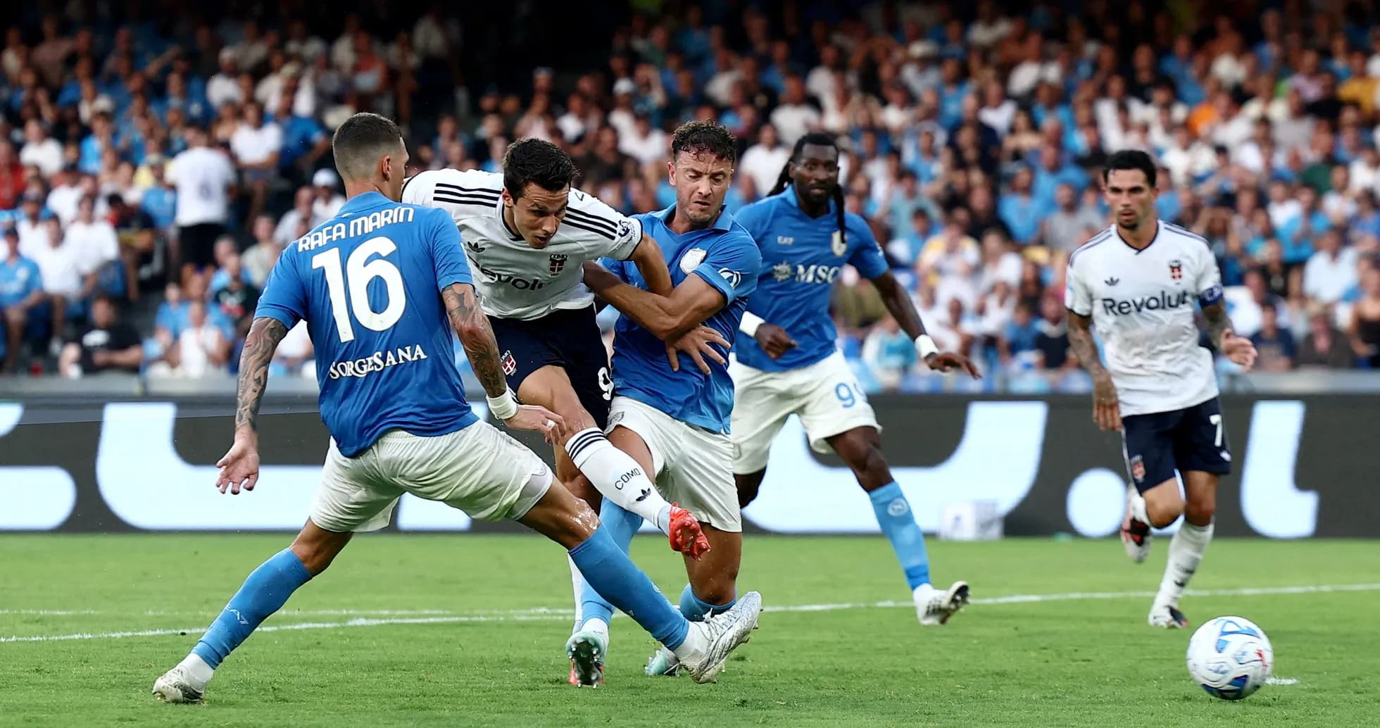 Napoli players defending against Como striker