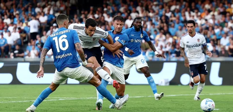 Napoli players defending against Como striker