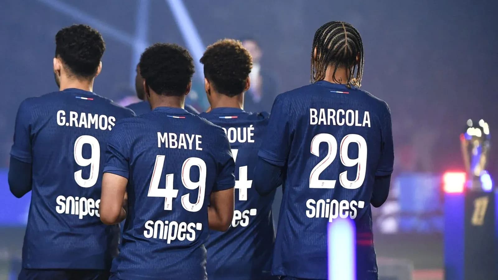 Players from a team in blue jerseys, back view