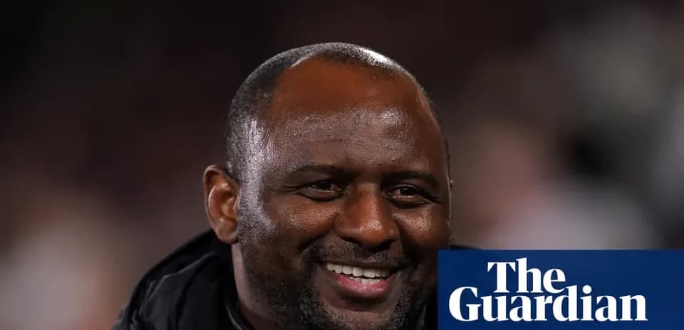 Smiling coach on sidelines during a match