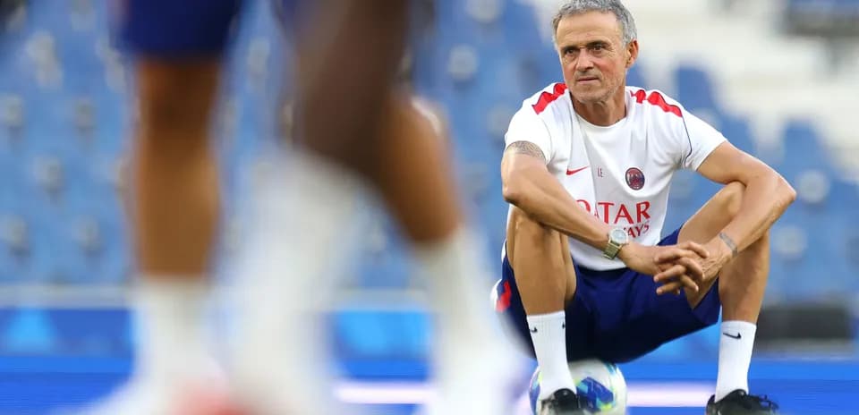 Coach observing players during training session