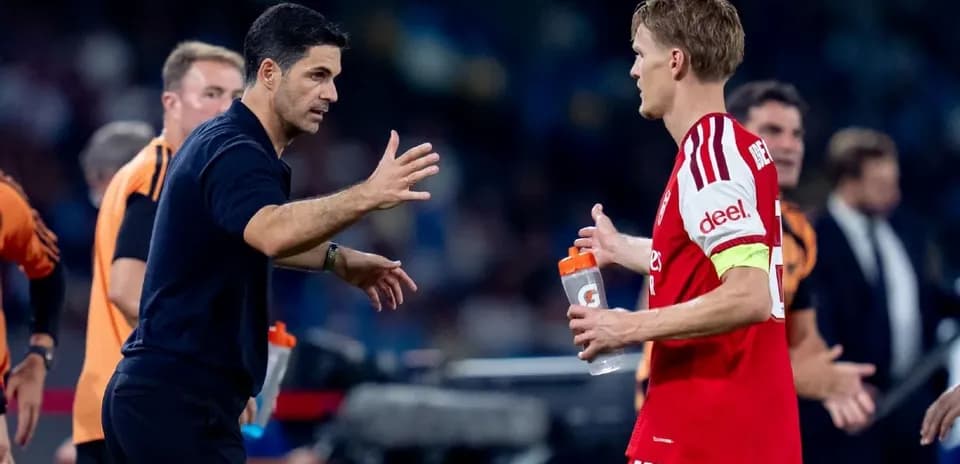 Manager discussing strategy with player on sideline