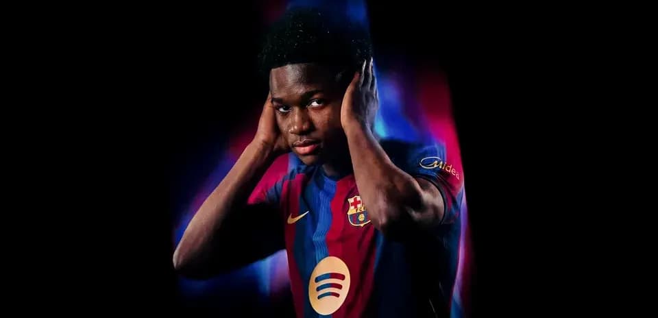 Player wearing FC Barcelona jersey posing with hands on ears