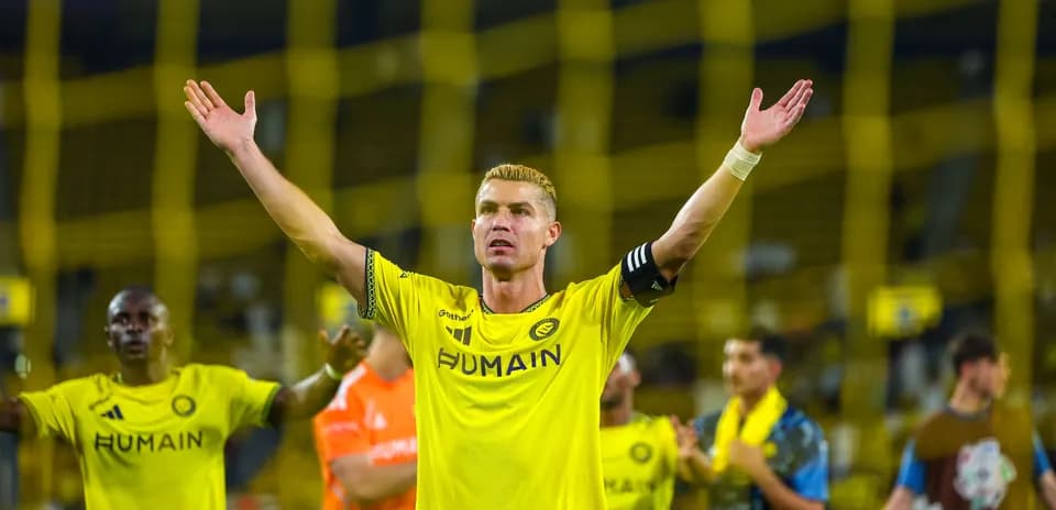 Player celebrating with arms raised after match