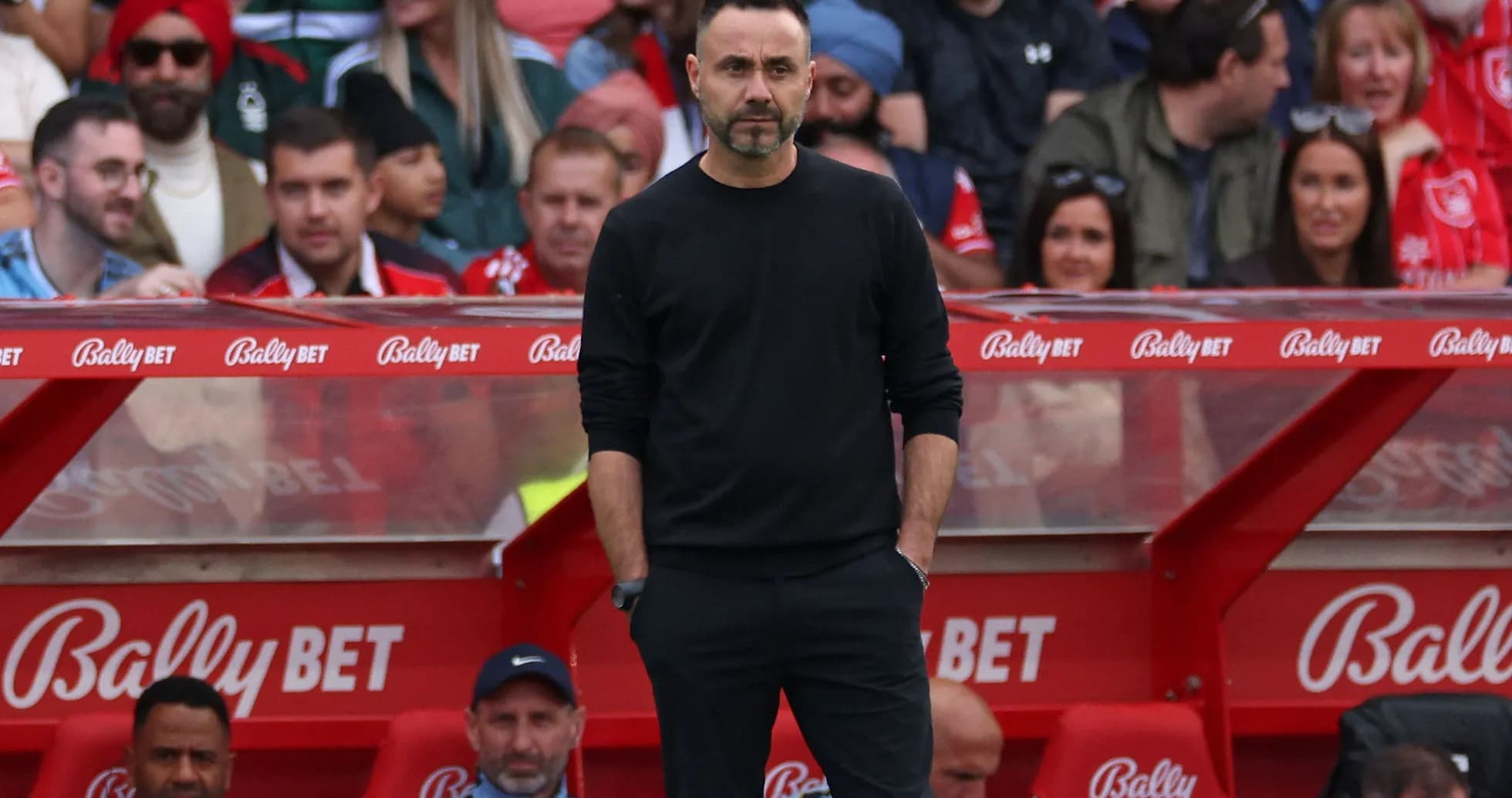 Coach standing on sidelines during match
