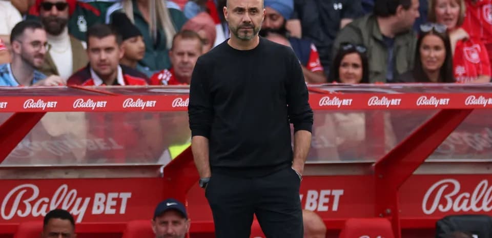 Coach standing on sidelines during match