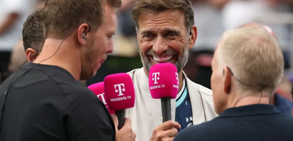 Interview with hosts holding microphones on stage