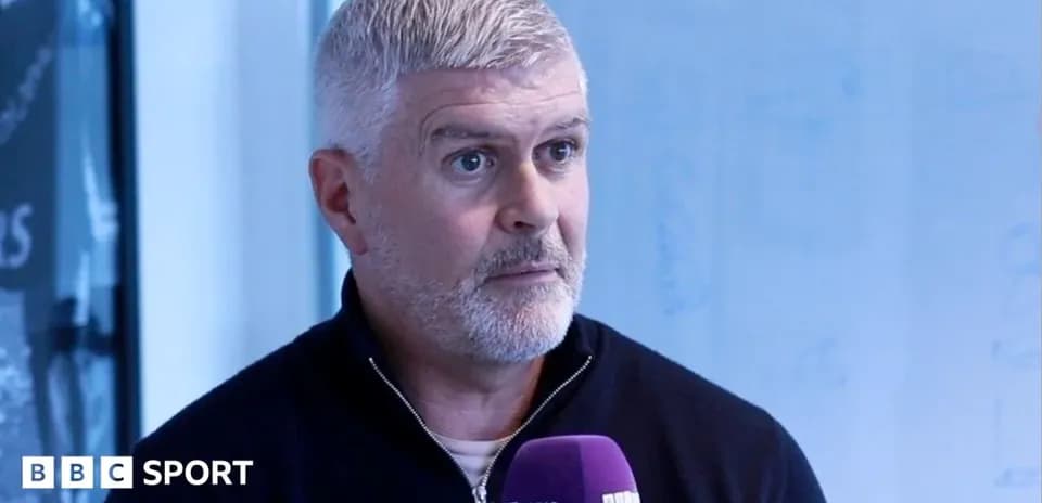 Man speaking during an interview with microphone