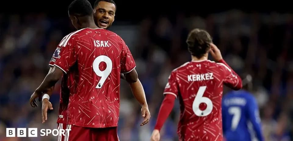Players celebrating, wearing red jerseys with numbers