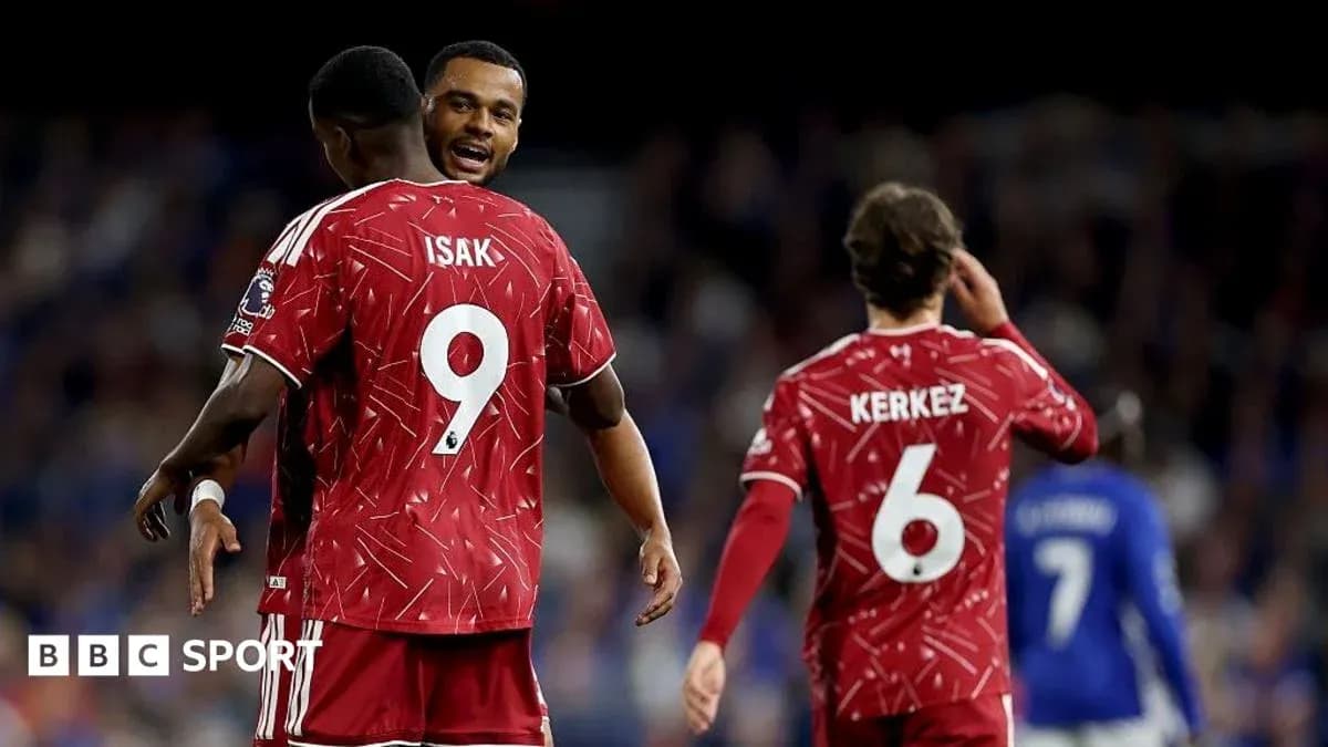 Players celebrating, wearing red jerseys with numbers