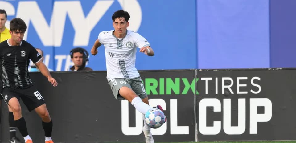Player dribbling ball during USL Cup match