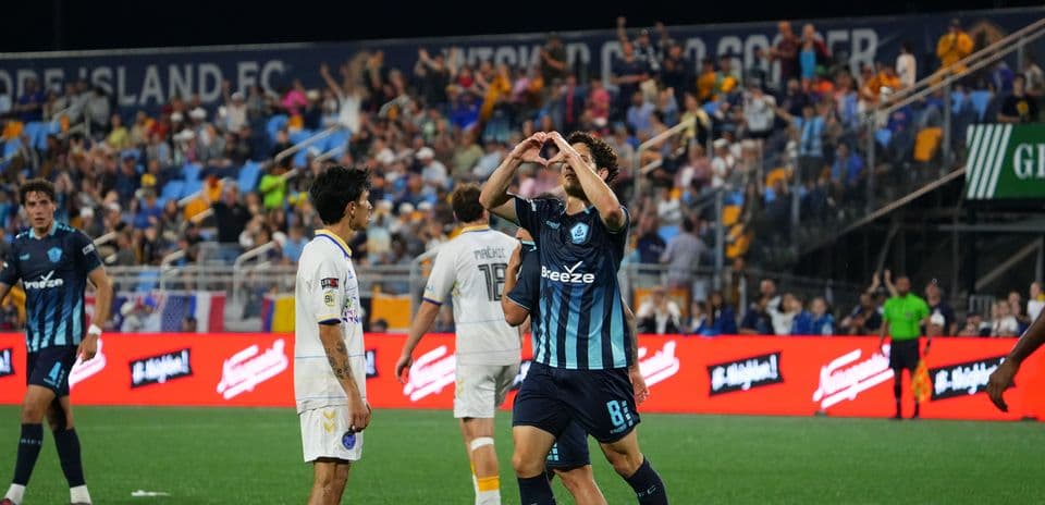 Player celebrating goal during Rhode Island match