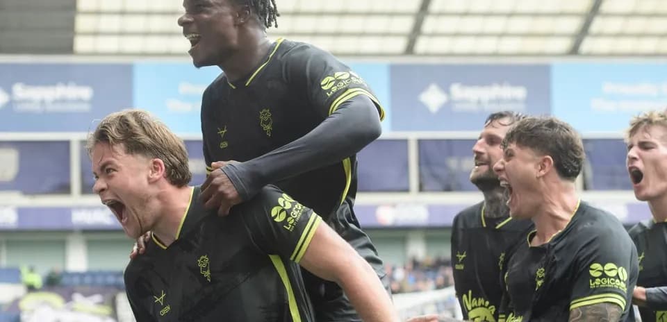 Players celebrating a goal during a match