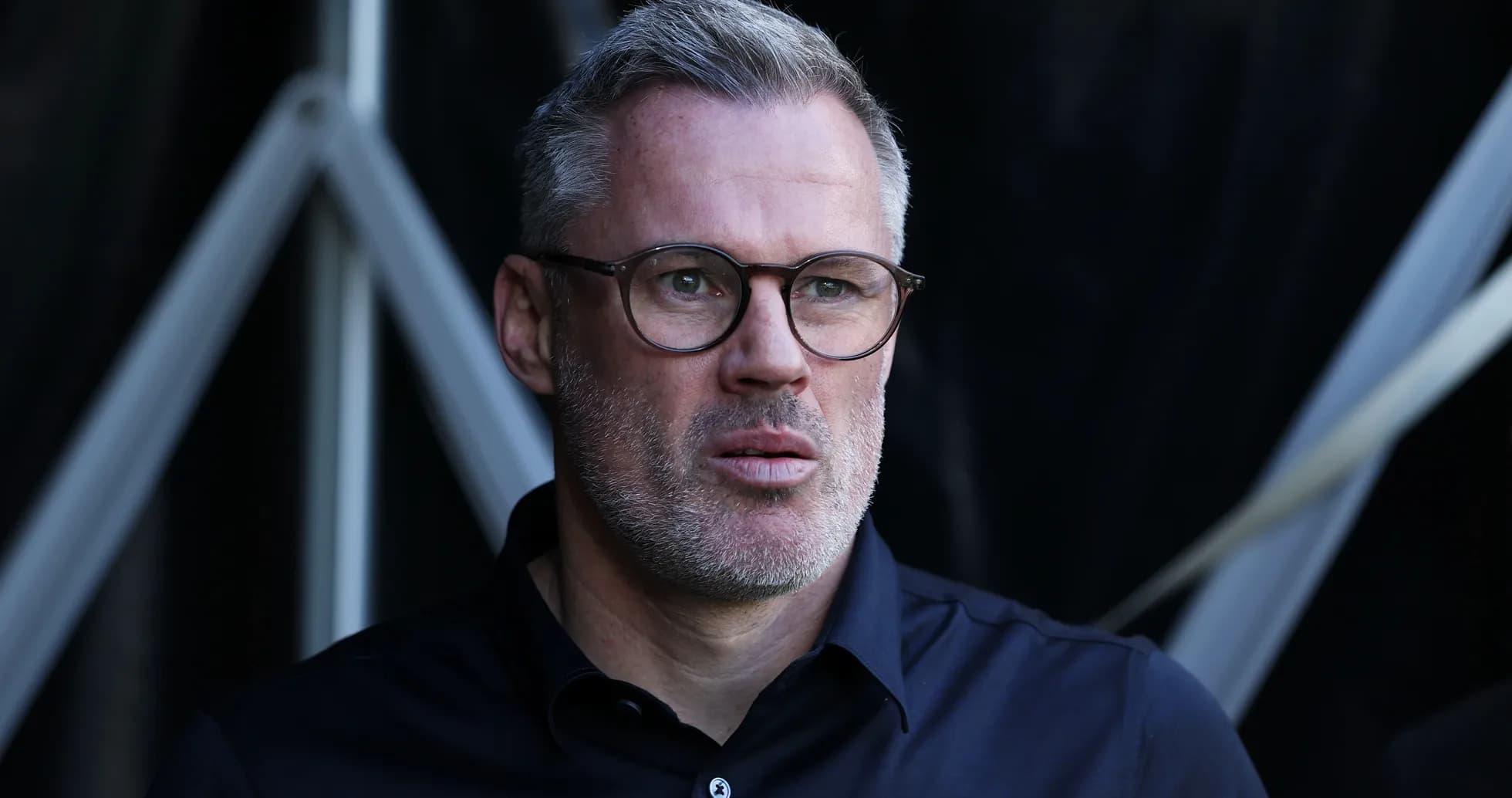 Man in glasses looking intently off-camera