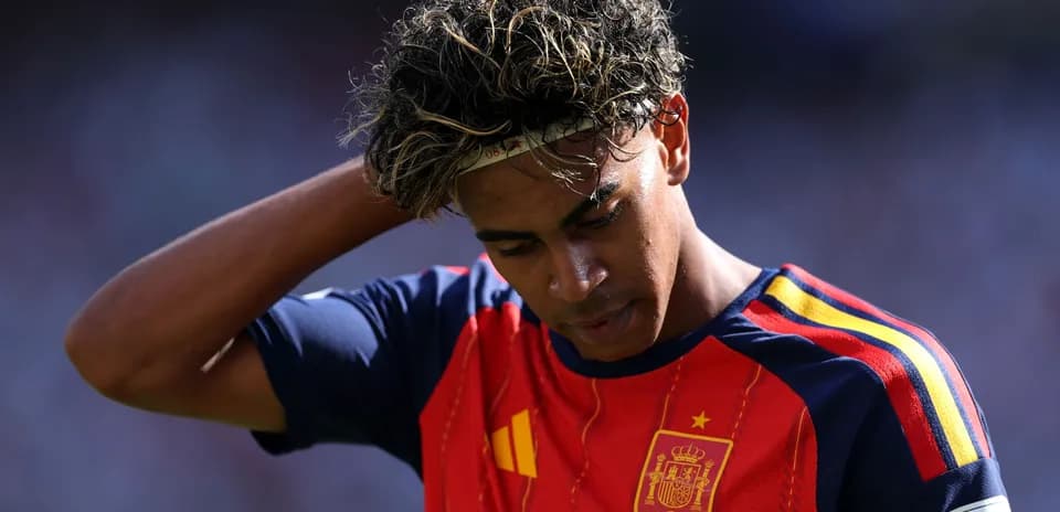 Player in Spain jersey looking down on field