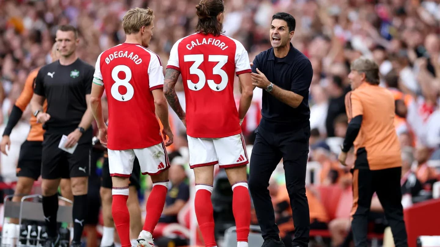 Arsenal players and manager discussing during match