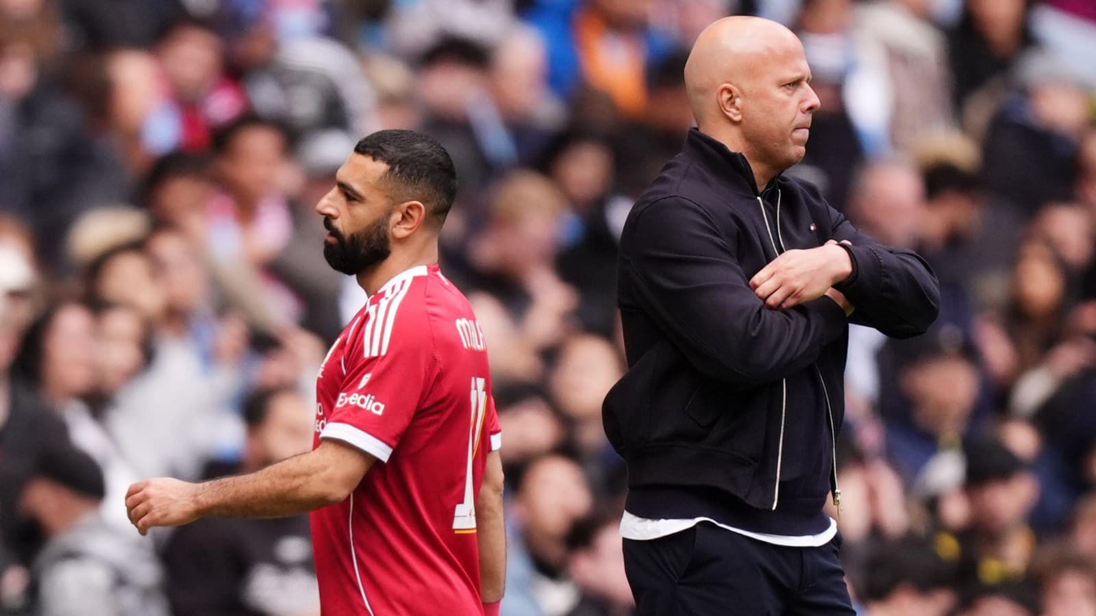 Player walking past coach on the sideline