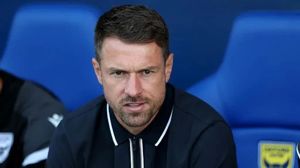 Coach sitting on bench during match