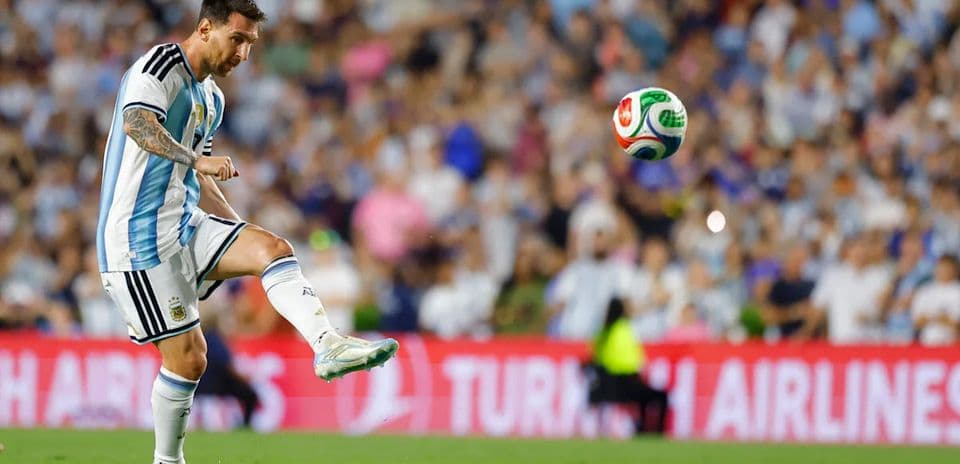 Player striking a soccer ball during match