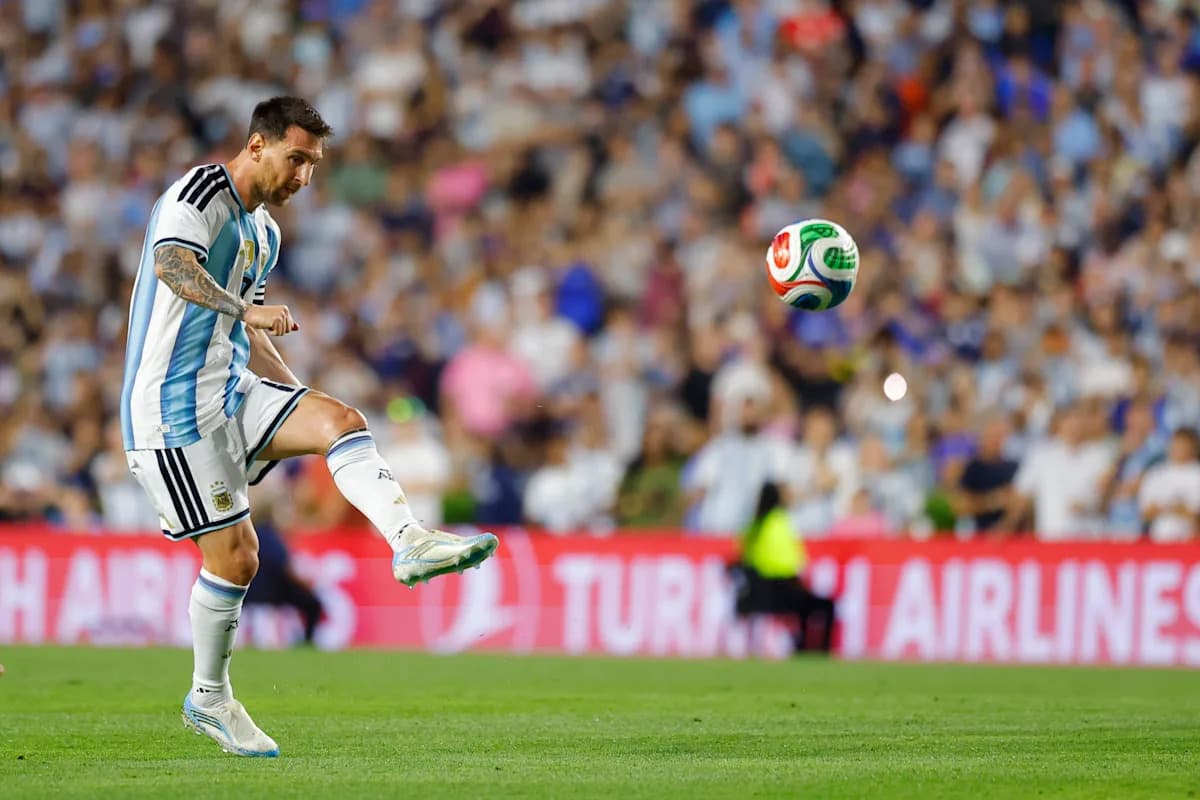 Player striking a soccer ball during match