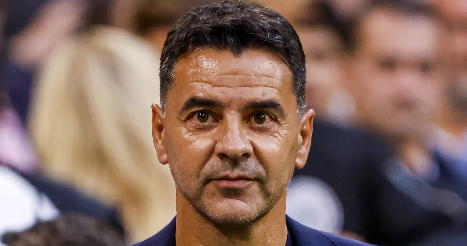 Man with short hair looking at the camera