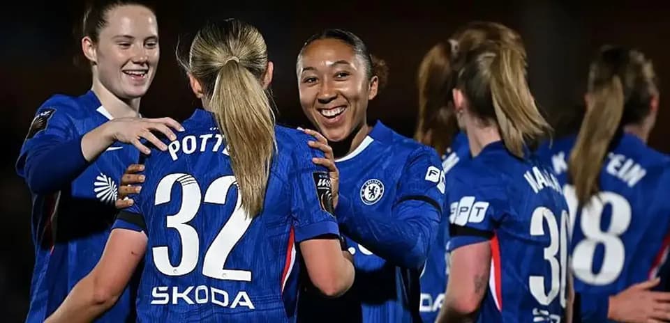 Chelsea Women discussing strategy during a match.