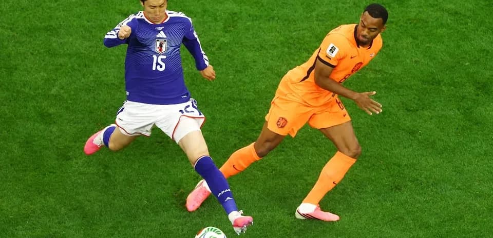 Player from Japan and Netherlands competing for ball
