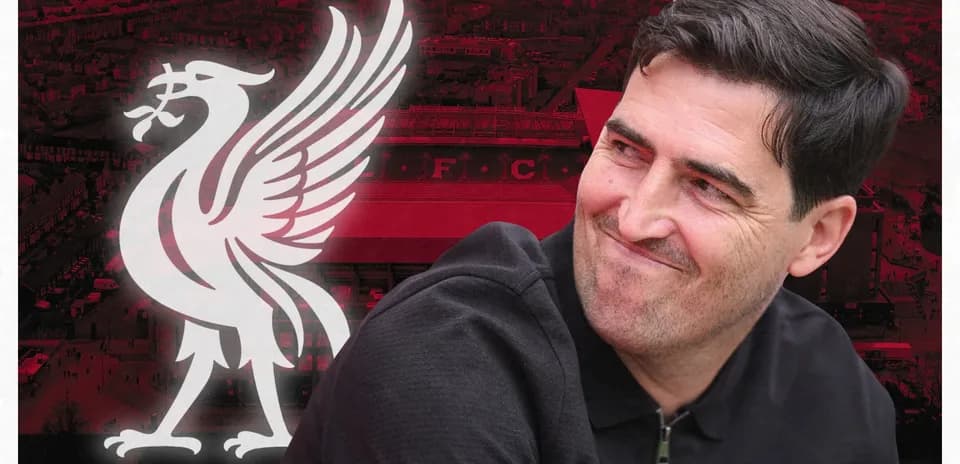 Person smiling in front of Liverpool FC logo