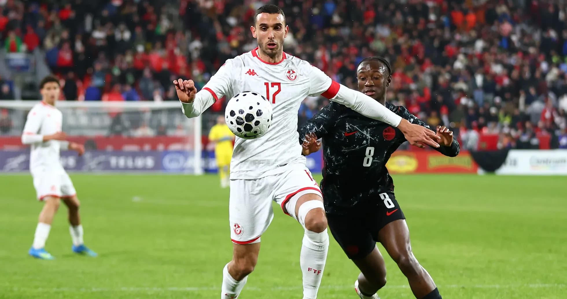 Two players contesting for the ball during match