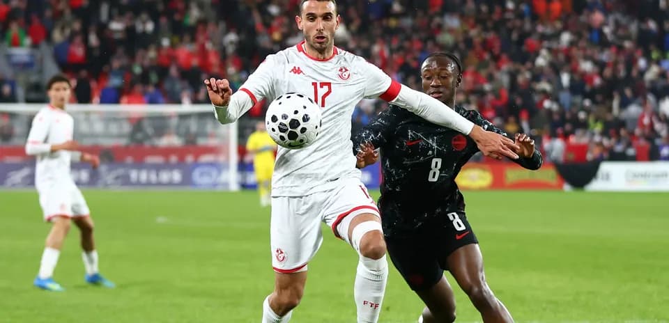Two players contesting for the ball during match