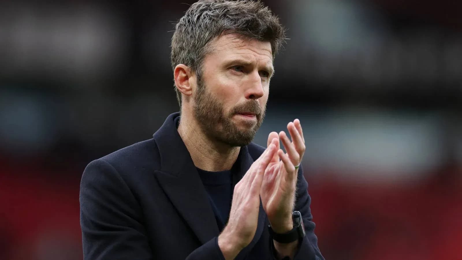 Coach applauding during a match at the stadium