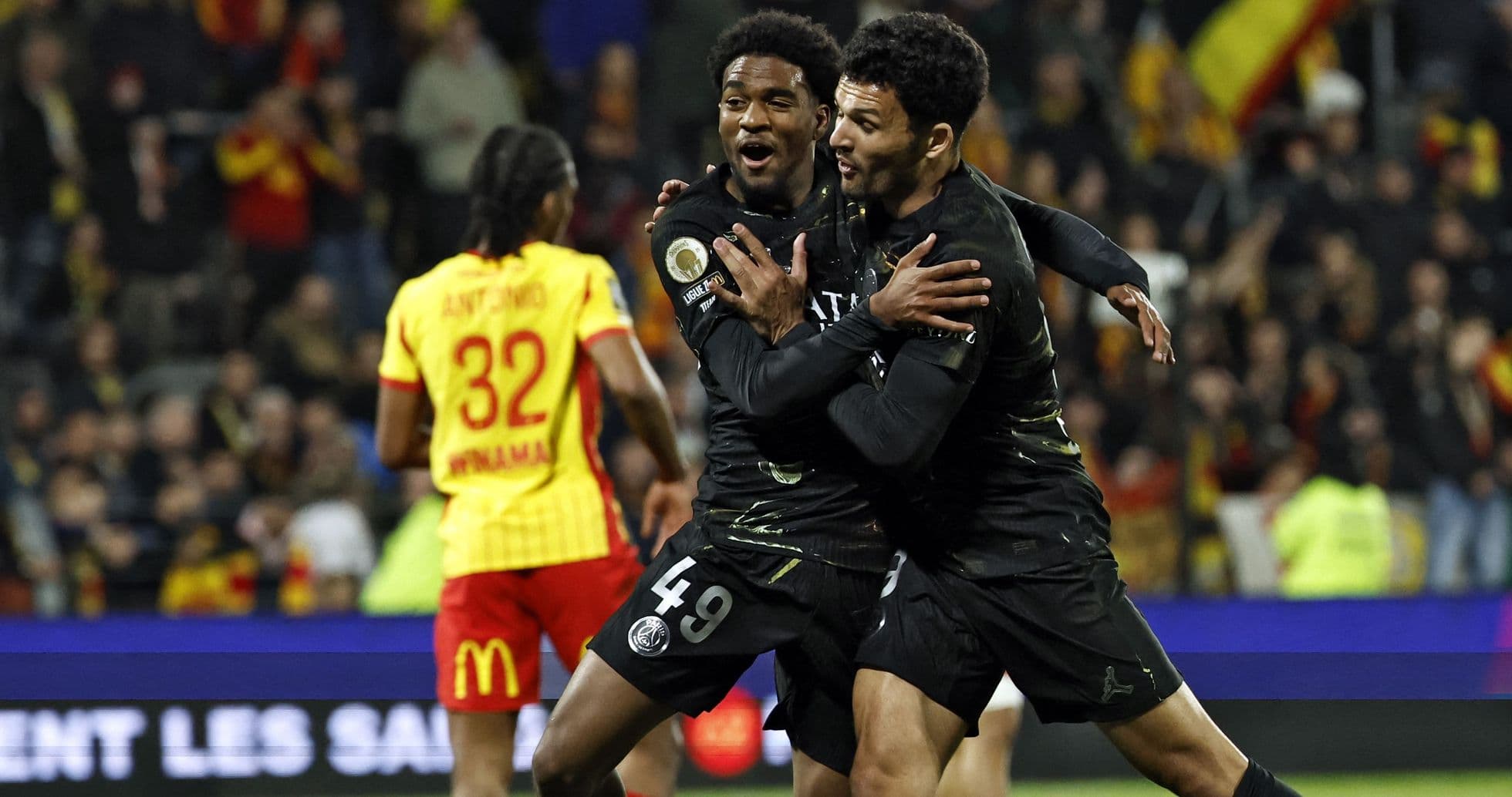 Two PSG players celebrating a goal during match