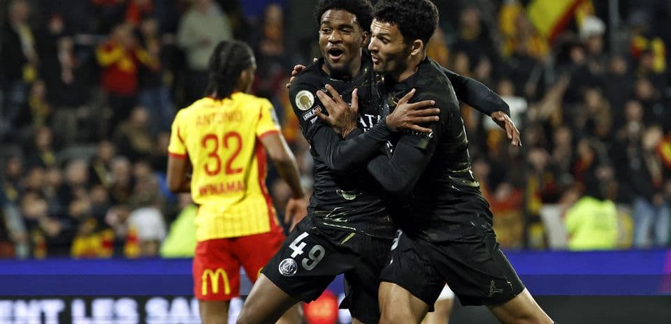 Two PSG players celebrating a goal during match