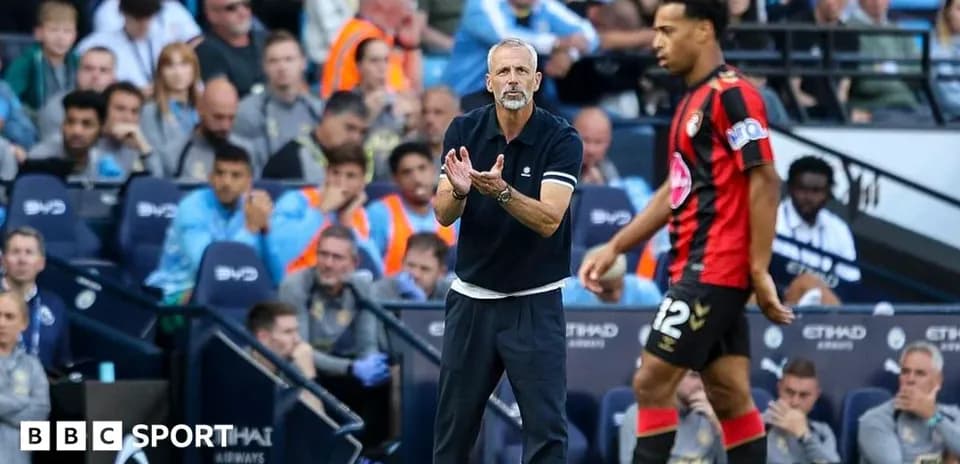 Manager directing player during match at stadium