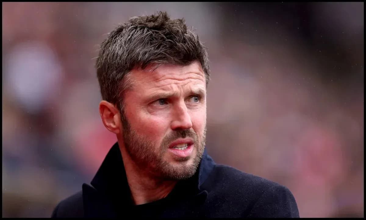Man in black coat at a football match