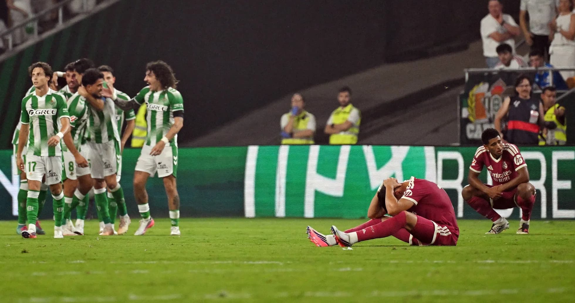Players celebrating a goal while opponents react in despair