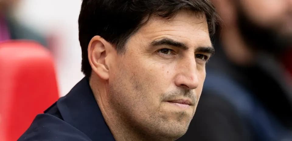 Coach observing from the sidelines during match