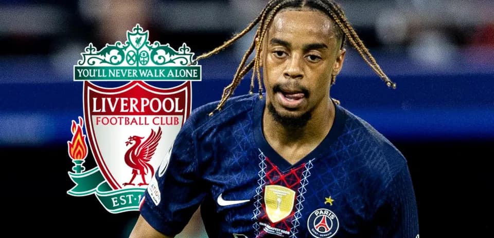 Player in PSG kit running with Liverpool logo in background