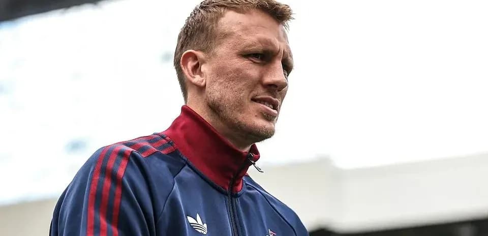 Player wearing training jacket at stadium entrance