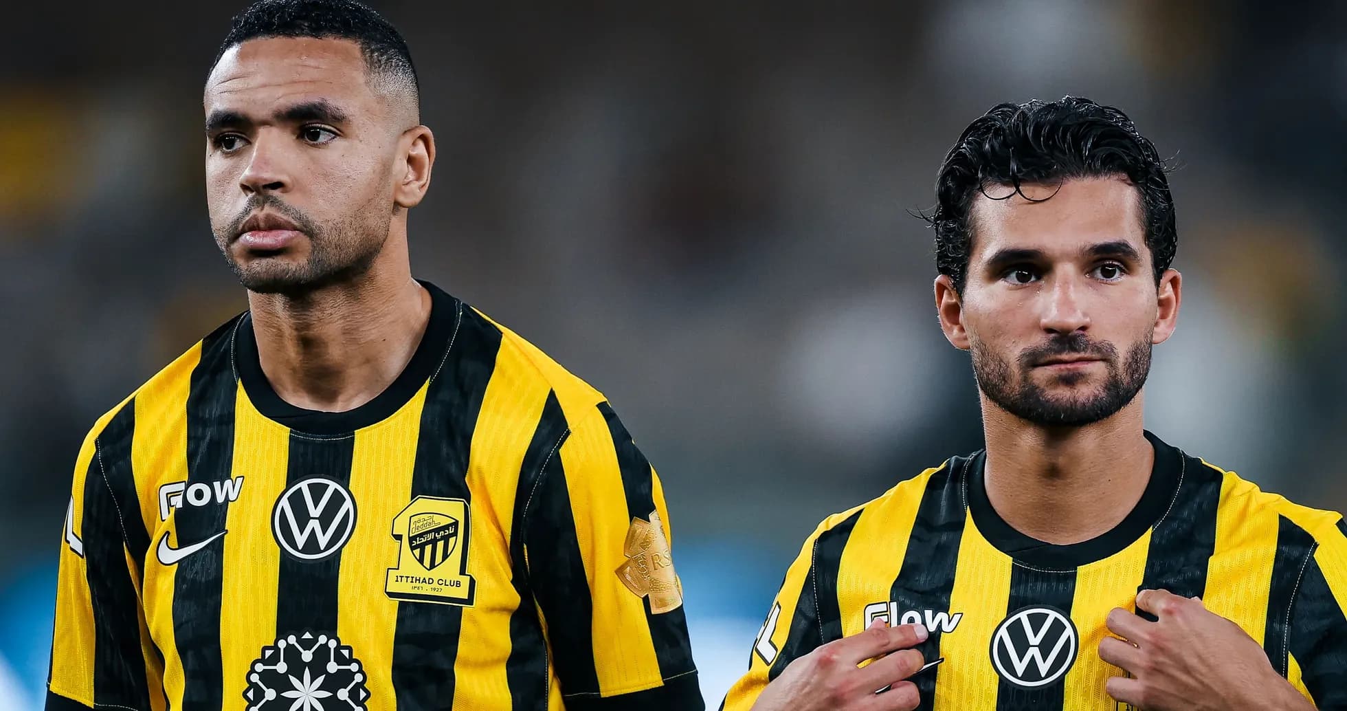Two players in yellow and black jerseys during match