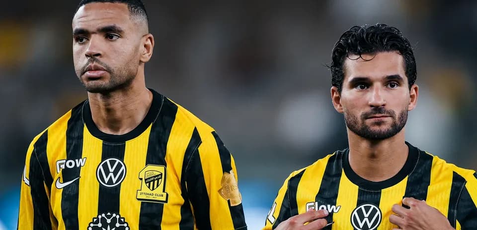 Two players in yellow and black jerseys during match