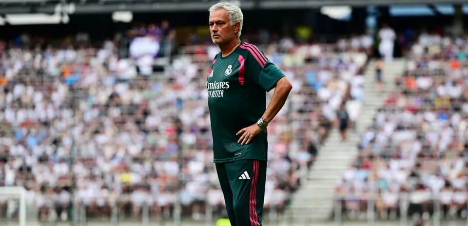 Coach observing match from the sidelines with crowd