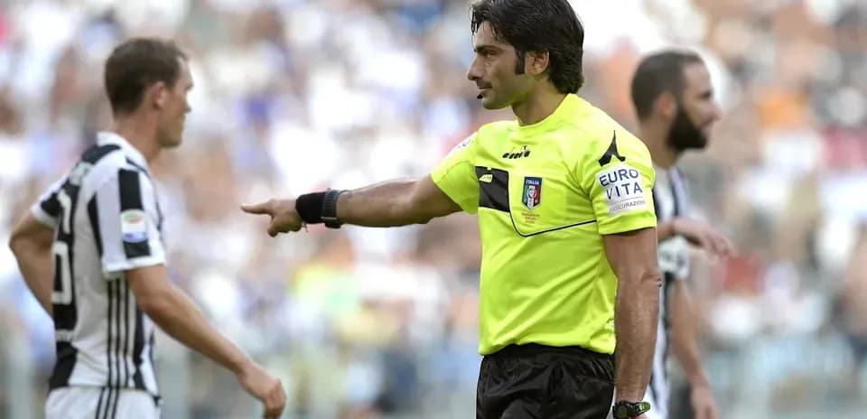 Referee gesturing during Juventus match with players