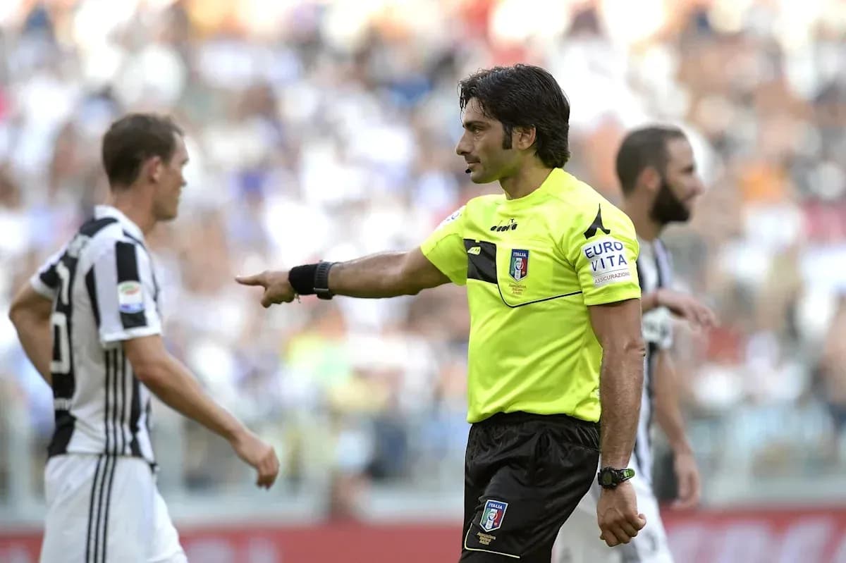 Referee gesturing during Juventus match with players