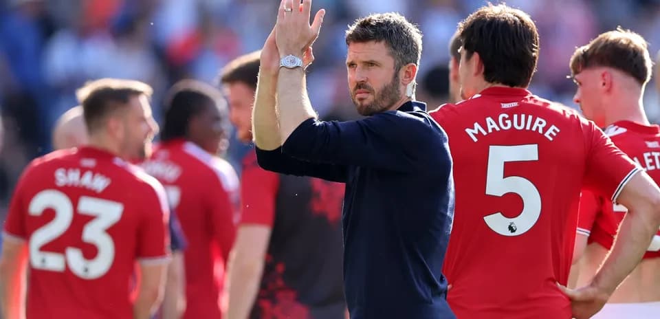 Manager applauding players after the match