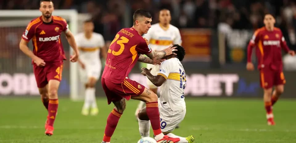 Player tackling opponent during Lecce vs AS Roma match