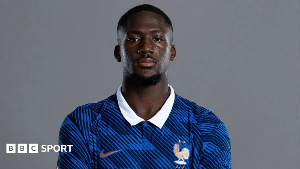 Player wearing France national team jersey, posing