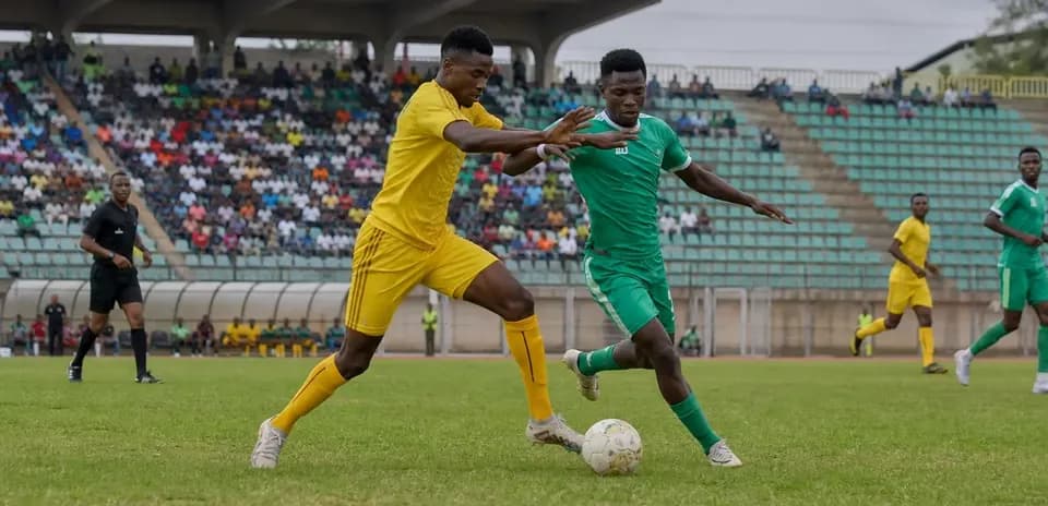 Players competing for the ball in football match