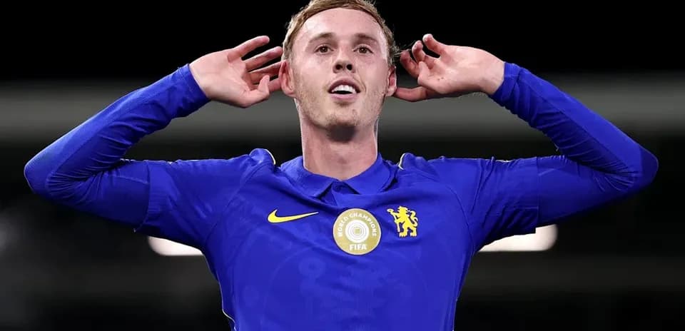 Player celebrating with hands to ears in blue jersey